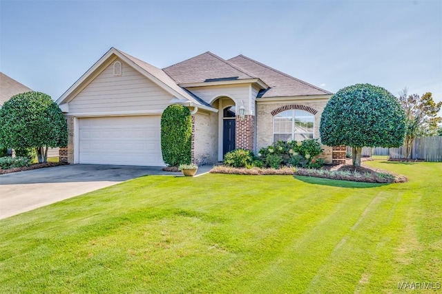 view of front of house with a garage and a front yard