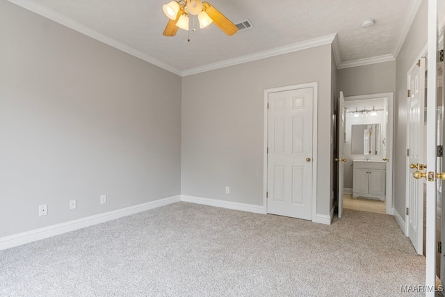 unfurnished bedroom with connected bathroom, crown molding, ceiling fan, and light colored carpet