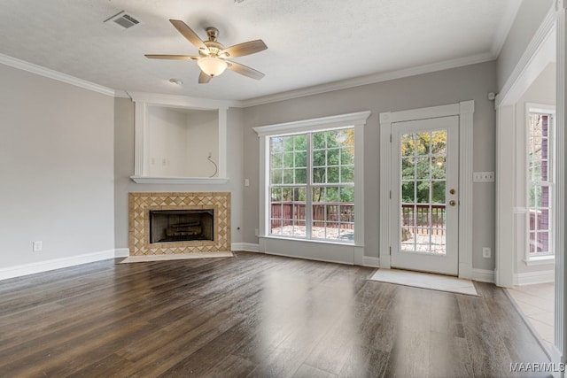 unfurnished living room with a textured ceiling, ceiling fan, crown molding, and a fireplace