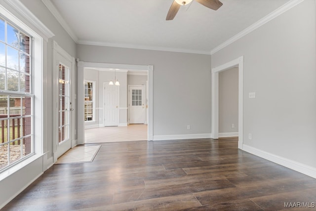 spare room featuring hardwood / wood-style floors, ceiling fan with notable chandelier, and ornamental molding