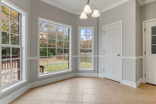 unfurnished dining area featuring a chandelier, light tile patterned floors, and crown molding