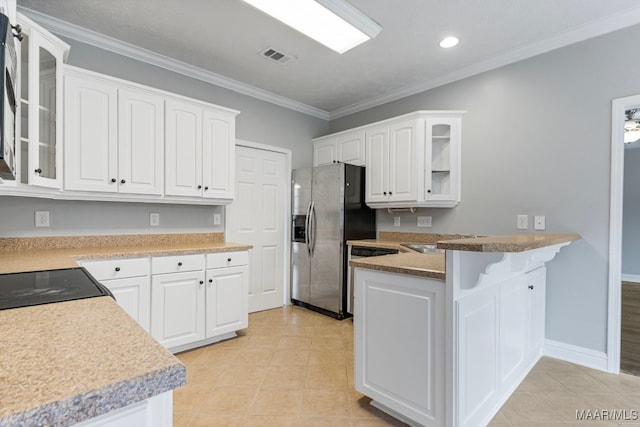 kitchen with white cabinets, sink, ornamental molding, and stainless steel refrigerator with ice dispenser