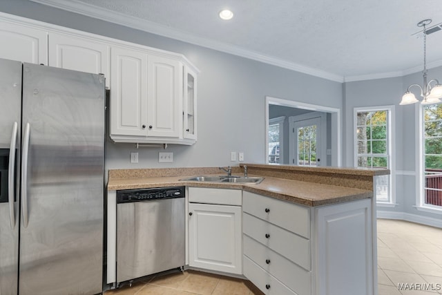 kitchen with white cabinets, sink, a notable chandelier, light tile patterned flooring, and stainless steel appliances