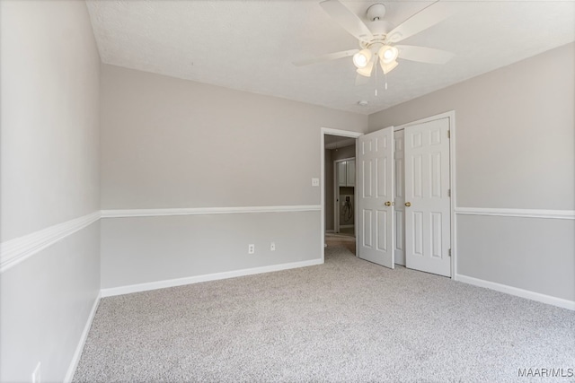 unfurnished room featuring carpet flooring and ceiling fan