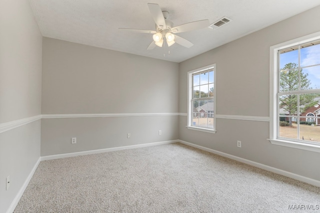 carpeted spare room featuring ceiling fan