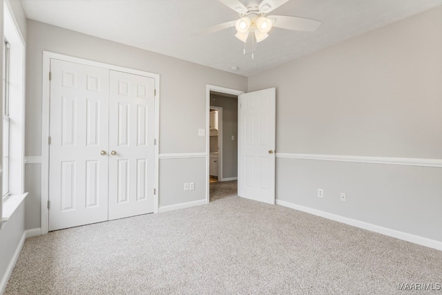 unfurnished bedroom with ceiling fan, a closet, and carpet