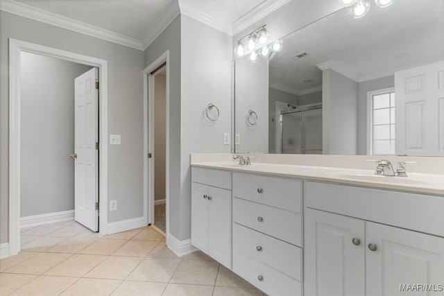 bathroom with tile patterned flooring, vanity, a shower with shower door, and ornamental molding