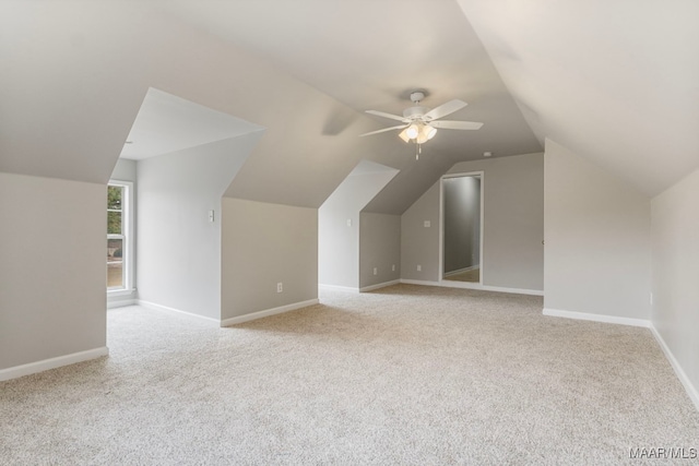 additional living space featuring ceiling fan, light carpet, and vaulted ceiling