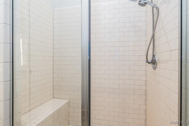 bathroom featuring a shower with shower door