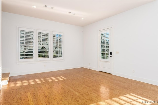 spare room with light wood-type flooring