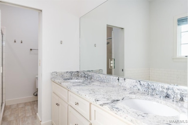 bathroom featuring vanity, toilet, and walk in shower