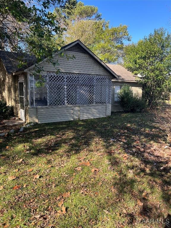 view of side of home featuring a lawn