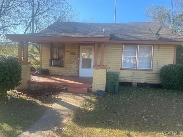 bungalow-style house with a porch and a front yard