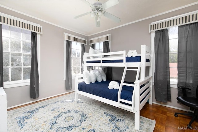 bedroom featuring ceiling fan, crown molding, and parquet flooring