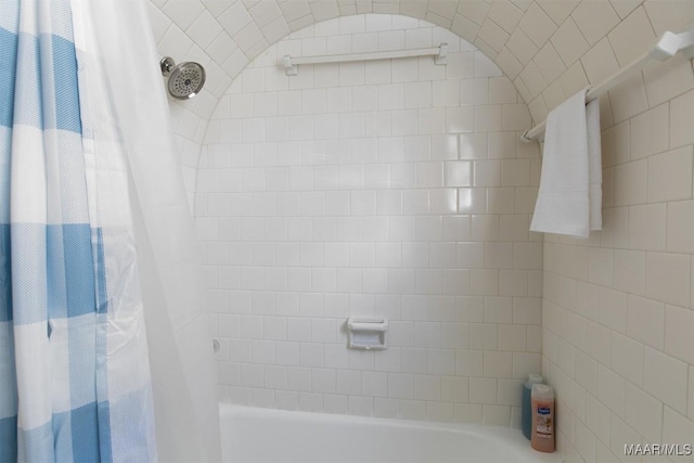 bathroom with shower / bath combo with shower curtain