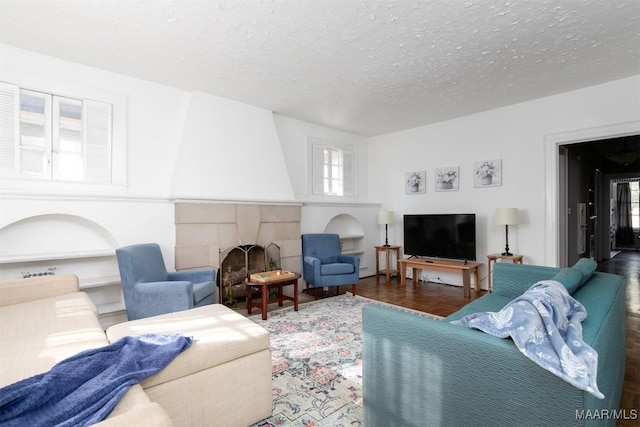 living room featuring dark parquet floors and a textured ceiling