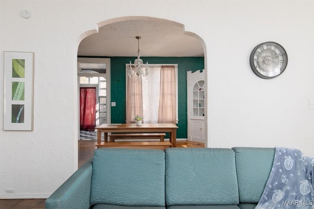 living room with a chandelier and wood-type flooring