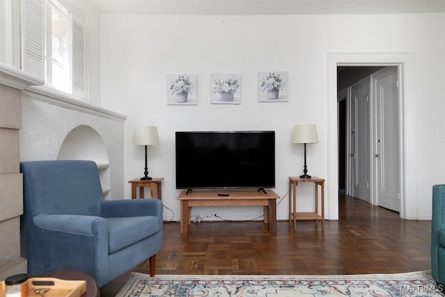 living room featuring dark parquet flooring