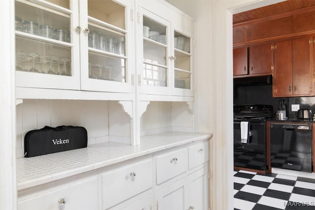 kitchen featuring black appliances, white cabinetry, and tile countertops