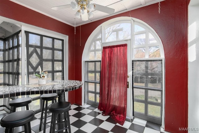 entrance foyer featuring crown molding and ceiling fan