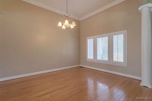 unfurnished room featuring light hardwood / wood-style floors, ornate columns, crown molding, and a chandelier