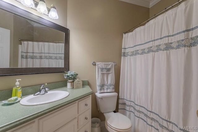 bathroom with vanity, toilet, and ornamental molding