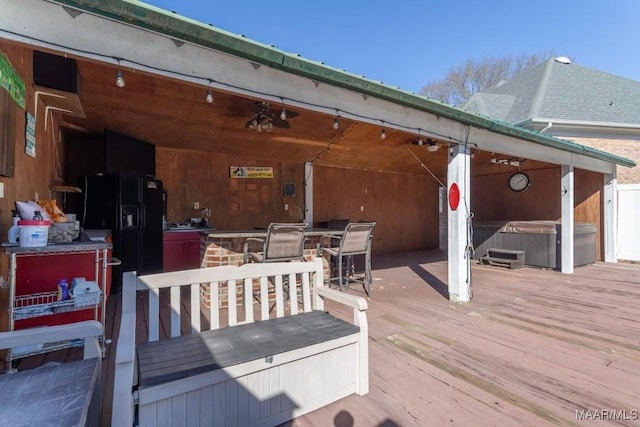 deck with exterior bar and a hot tub