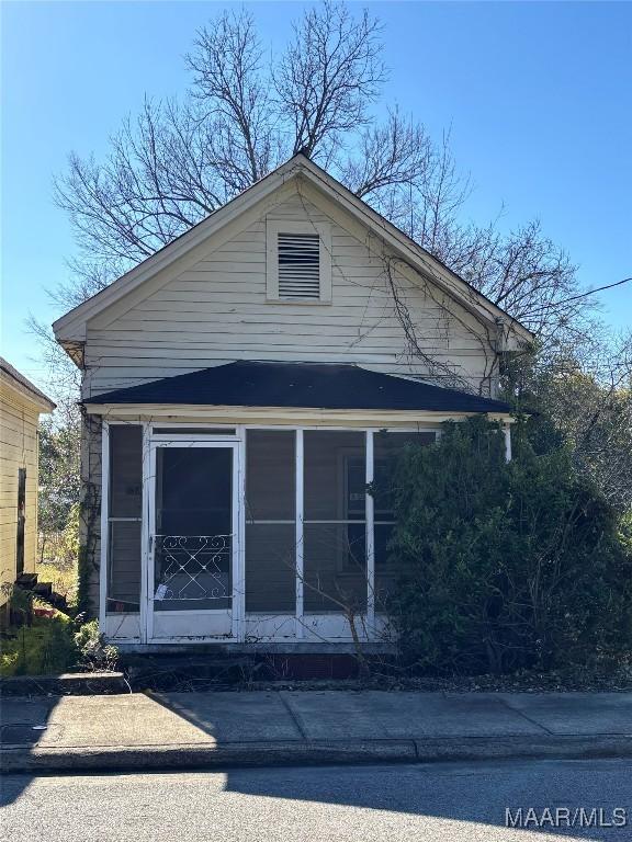 view of side of home with a sunroom