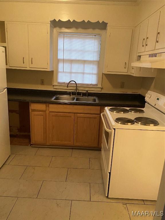 kitchen featuring white cabinetry, sink, light tile patterned flooring, and white appliances