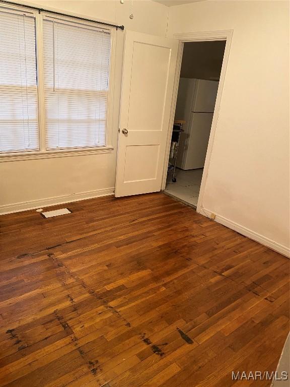 unfurnished room featuring dark hardwood / wood-style flooring