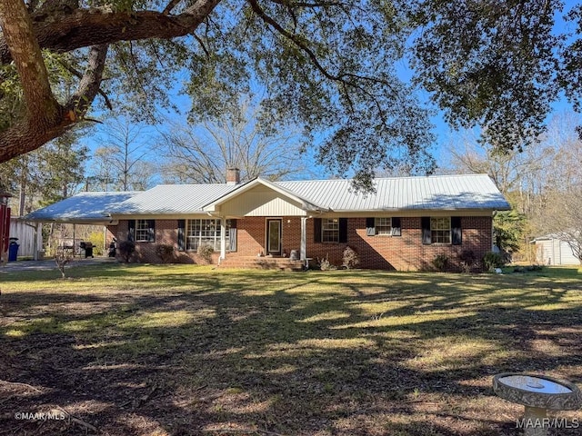 view of front of property with a front yard and a carport