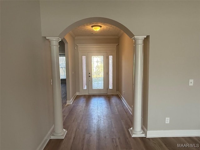 entryway featuring dark hardwood / wood-style flooring and ornamental molding