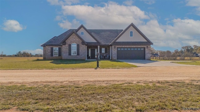 view of front of home with a front yard and a garage