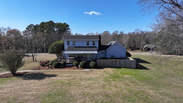 back of house with a lawn