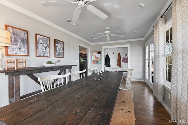 dining room featuring crown molding, ceiling fan, and dark hardwood / wood-style floors