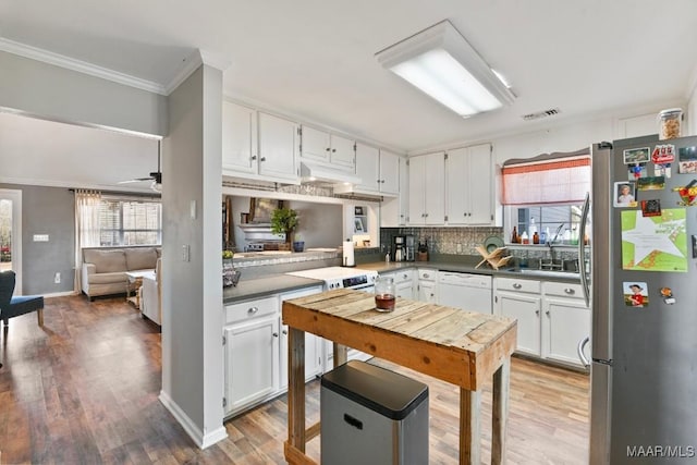 kitchen featuring white dishwasher, ceiling fan, sink, white cabinets, and stainless steel refrigerator