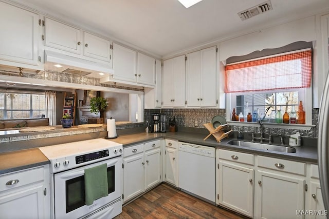 kitchen featuring backsplash, white dishwasher, sink, white cabinets, and range