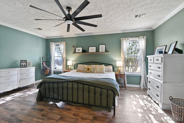 bedroom featuring ceiling fan, crown molding, dark wood-type flooring, and multiple windows