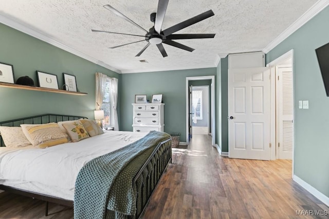 bedroom featuring hardwood / wood-style floors, ceiling fan, crown molding, and a textured ceiling