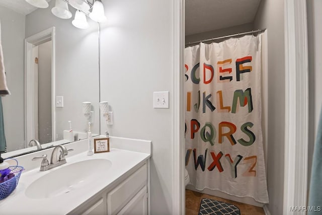 bathroom with vanity, a textured ceiling, and walk in shower