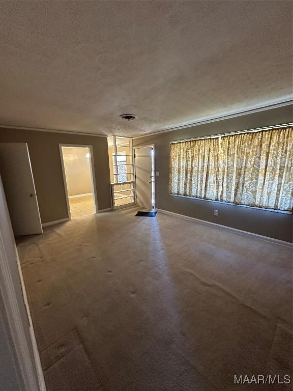 unfurnished room with a textured ceiling