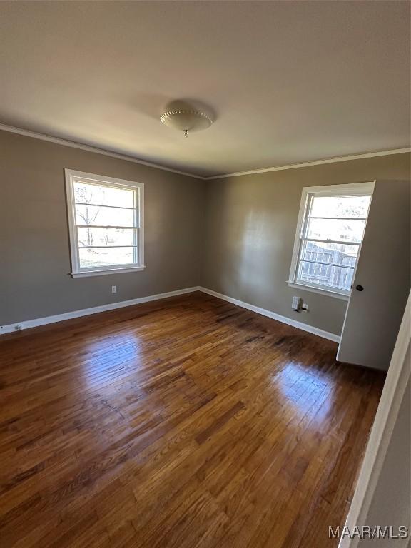 unfurnished room featuring dark hardwood / wood-style flooring and ornamental molding