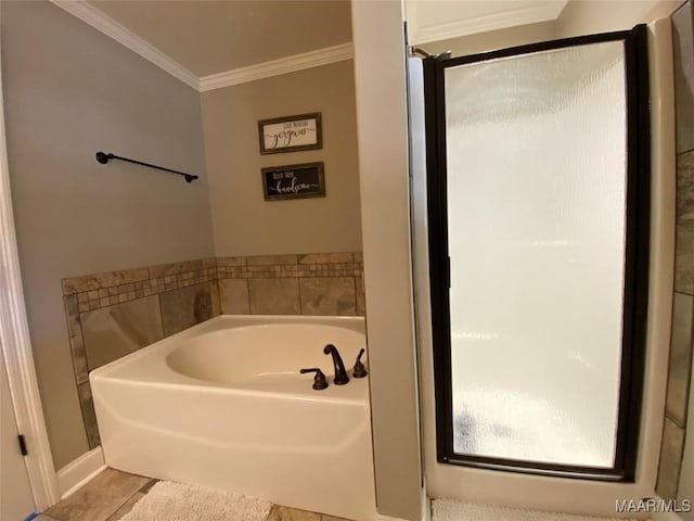 bathroom featuring tile patterned floors, ornamental molding, and a tub to relax in