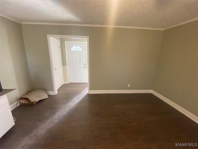 entrance foyer with dark hardwood / wood-style flooring and crown molding