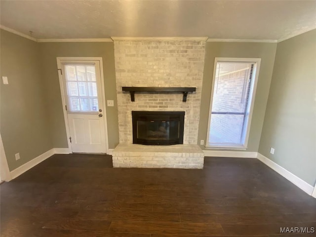 unfurnished living room featuring a fireplace, dark hardwood / wood-style floors, and ornamental molding