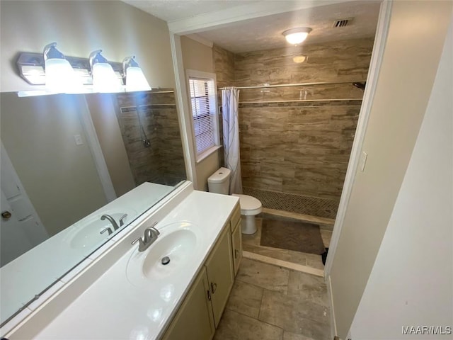 bathroom with a shower with shower curtain, vanity, and toilet