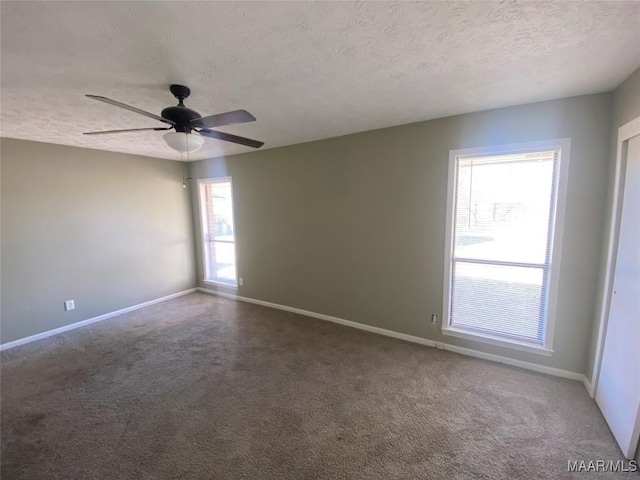 unfurnished room with carpet flooring, ceiling fan, and a textured ceiling