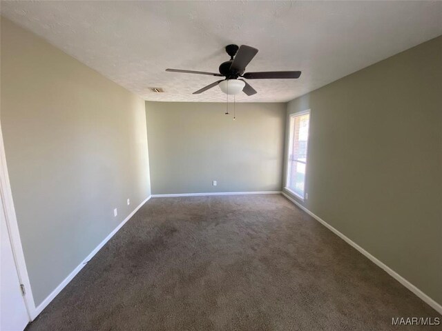 carpeted empty room featuring a textured ceiling and ceiling fan