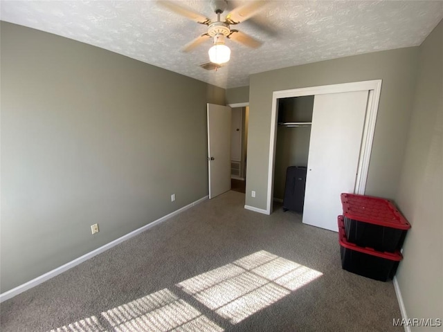 unfurnished bedroom with light carpet, a textured ceiling, a closet, and ceiling fan