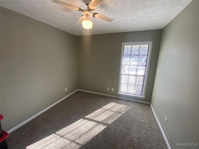 spare room with carpet, a textured ceiling, and ceiling fan